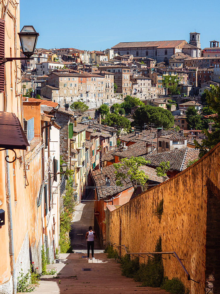 The view of Perugia's cityscape from an alley, with St. Lorenzo's Cathedral in the back, Perugia, Umbria, Italy, Europe