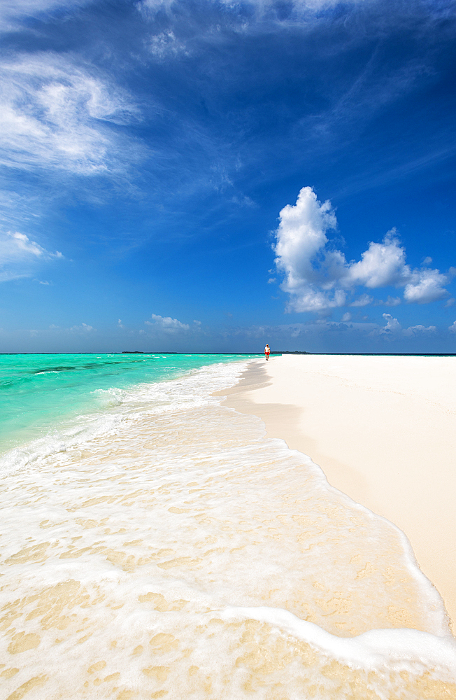 A man walking on a sanbank in the Indian Ocean, Baa Atoll, Maldives