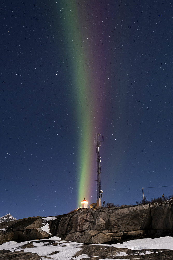 Vertical multi coloured stripes of the Aurora Borealis (Northern Lights) over Tungeneset Lighthouse, Tungeneset, Senja, Troms og Finnmark county, Norway, Scandinavia, Europe