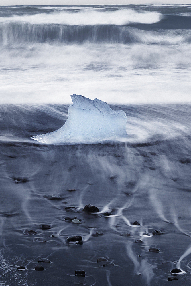 Iceberg or Growler shaped like a Glass Slipper on Fellsfjara Beach, nicknamed Diamond Beach, near Jokulsarlon, Southern Iceland, Europe