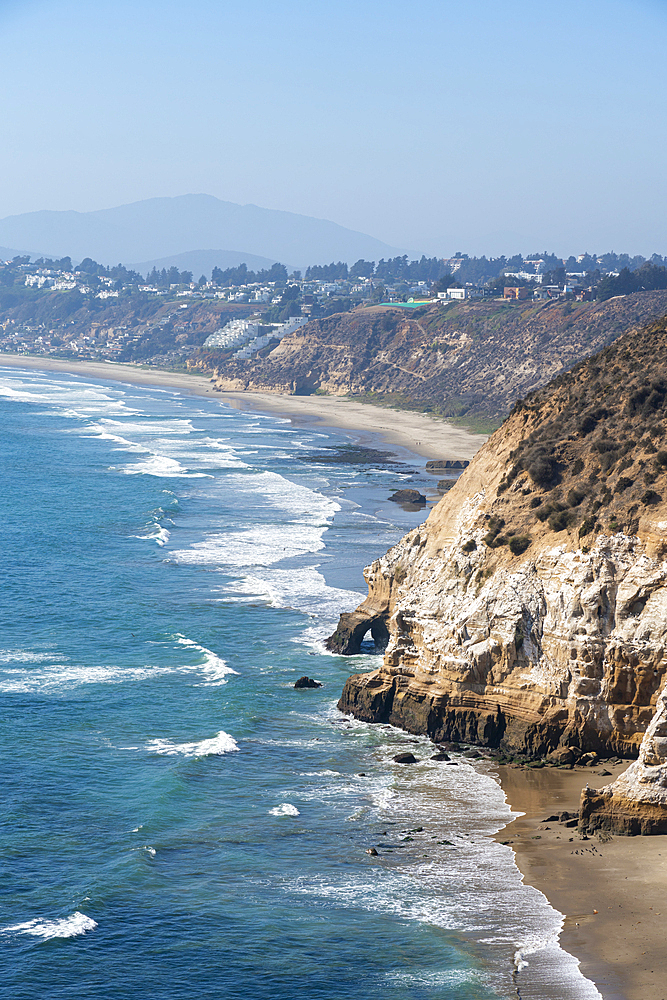 Cliffs along the coast with distant views of Maitencillo, Puchuncavi, Valparaiso Province, Valparaiso Region, Chile, South America