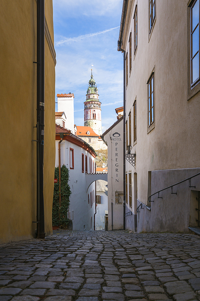 State Castle and Chateau Cesky Krumlov tower seen from narrow alley, UNESCO World Heritage Site, Cesky Krumlov, South Bohemian Region, Czech Republic (Czechia), Europe