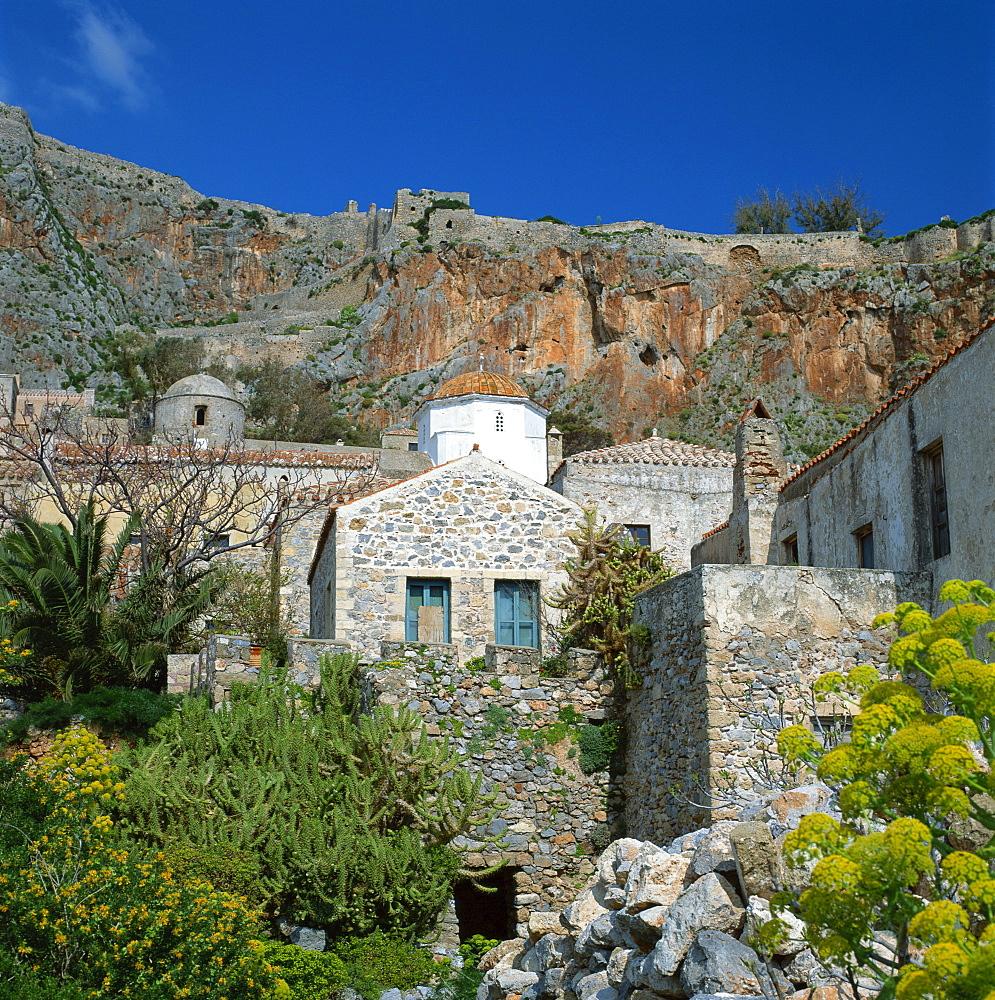 A church with cliffs behind at Monemvasia, known as the Gibraltar of Greece, Greece, Europe