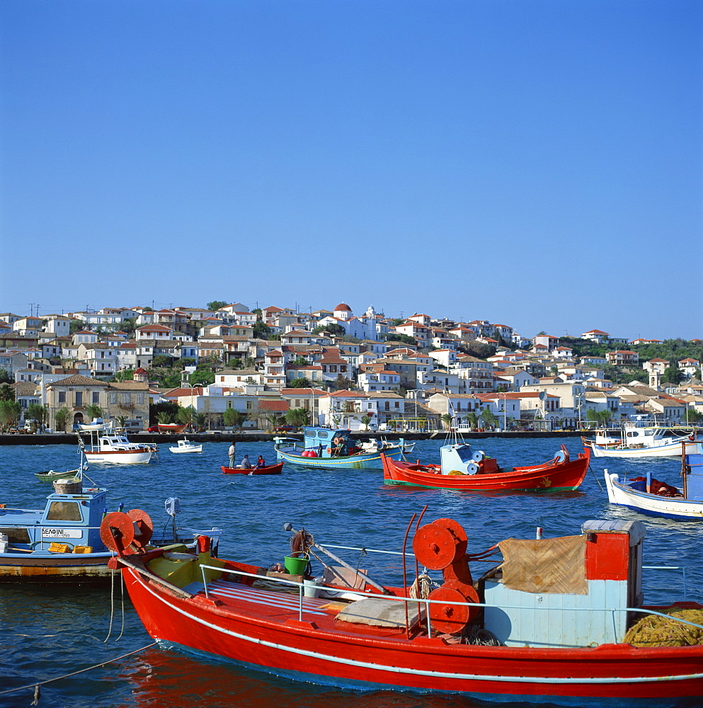 Red and blue painted fishing boats in the harbour in the seaside market and port town of Neapoli, Peloponnese, Greece, Europe