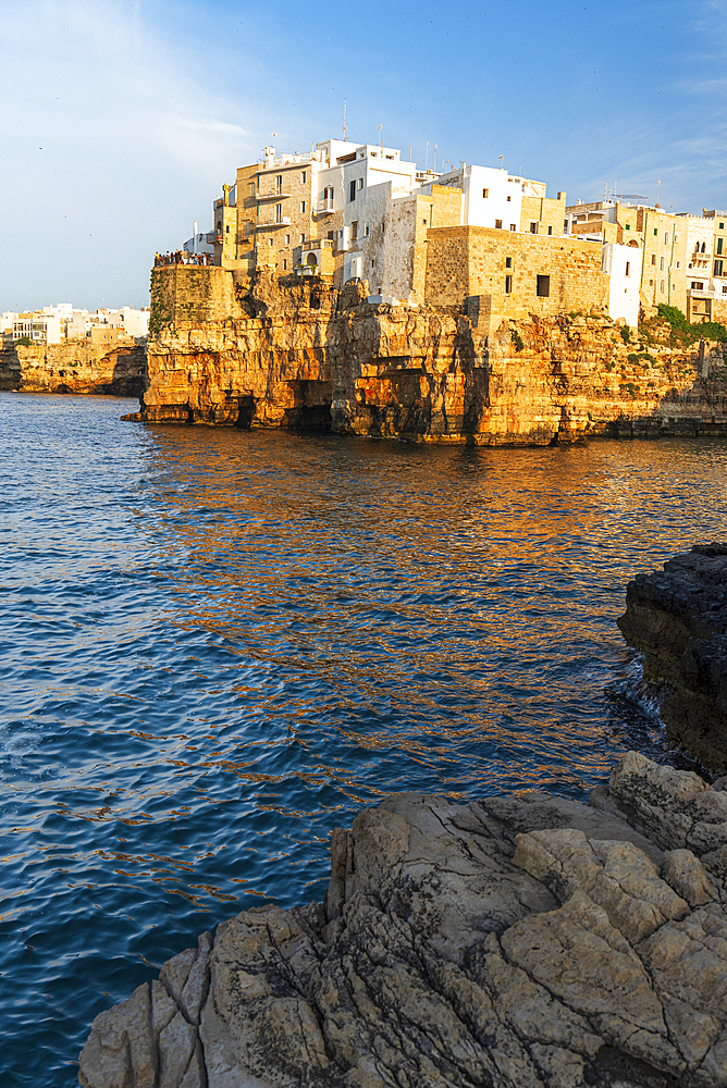 View of the medieval village of Polignano a Mare on top of the cliff at sunset, Bari, Apulia, Adriatic Sea, Mediterranean Sea, Italy, Europe