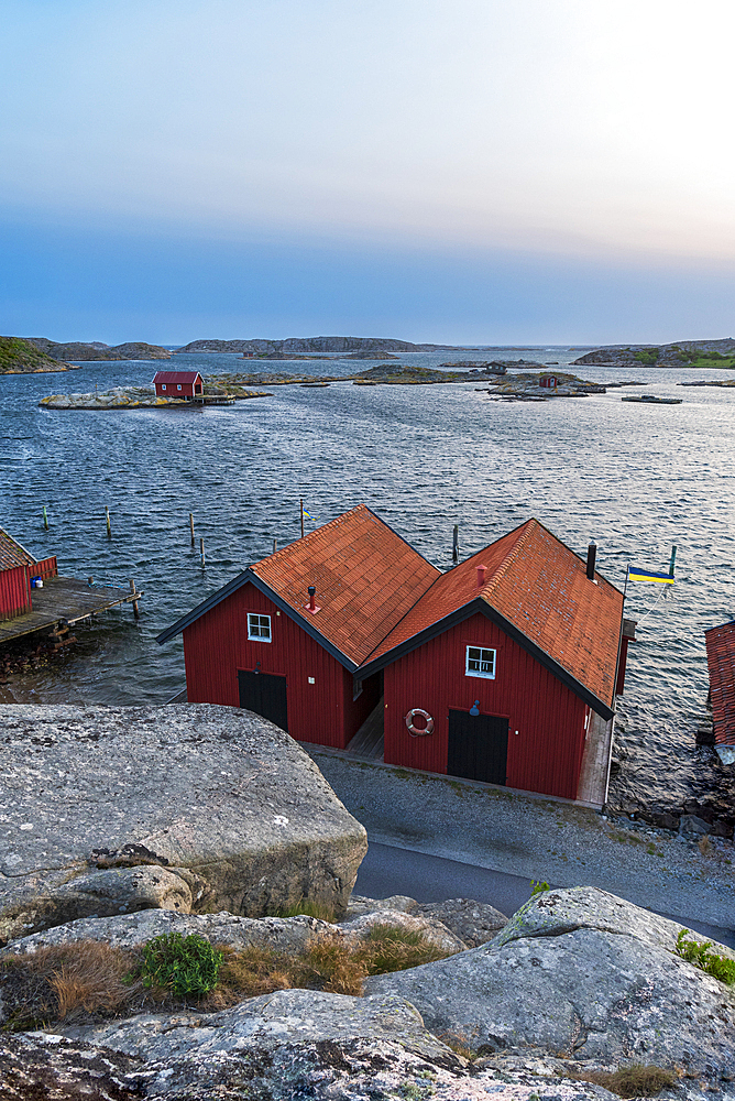 Wooden houses on rocky coast at dusk, Bohuslan, Vastra Gotaland, Sweden, Scandinavia, Europe