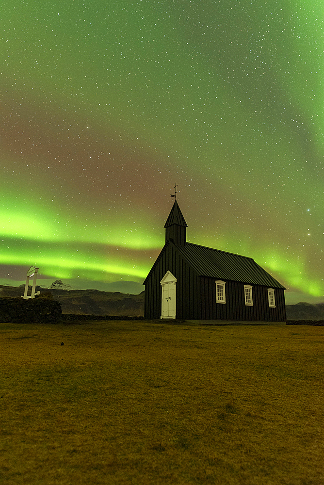 Iconic black wooden Budakirkja church under the Northern Lights (Aurora Borealis), Budir, Snaefellsness Peninsula, Vesturland, Iceland, Polar Regions