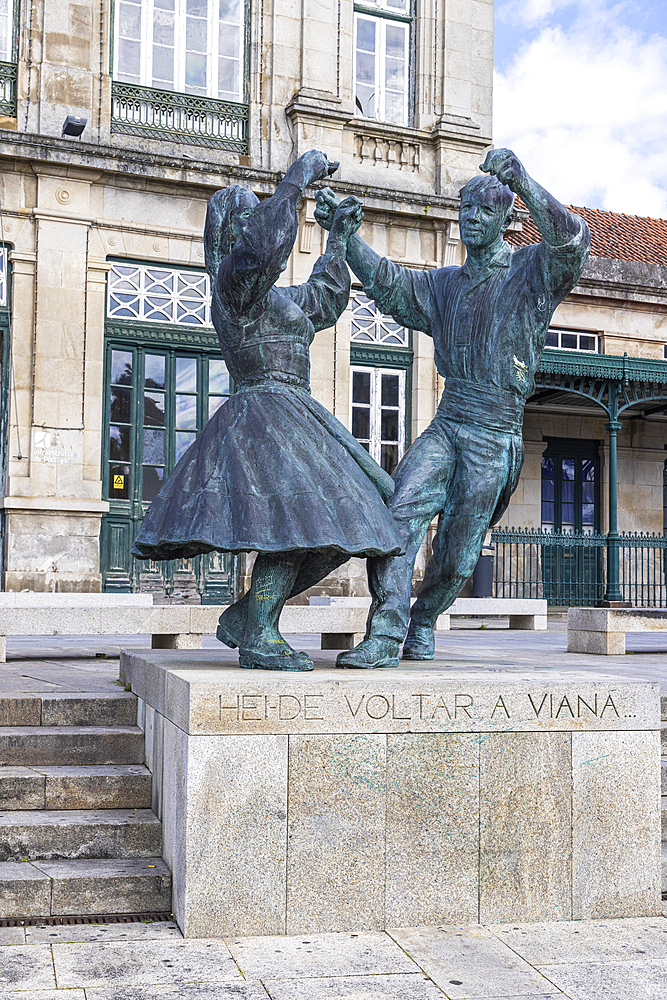 Europe, Portugal, Viana do Castelo. April 10, 2022. Statue of two dancers outside the train station, with test saying, "I'll go back to Viana."