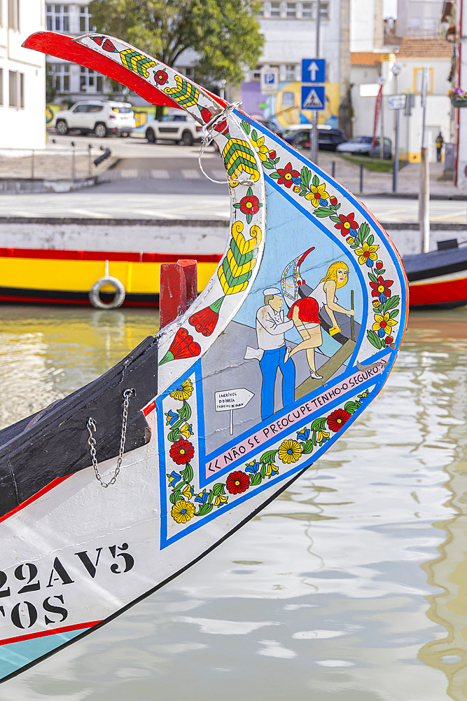 Europe, Portugal, Aveiro. April 12, 2022. Brightly painted moliceiros, traditional flat bottomed wooden boats, on the Central Canal in Aveiro.