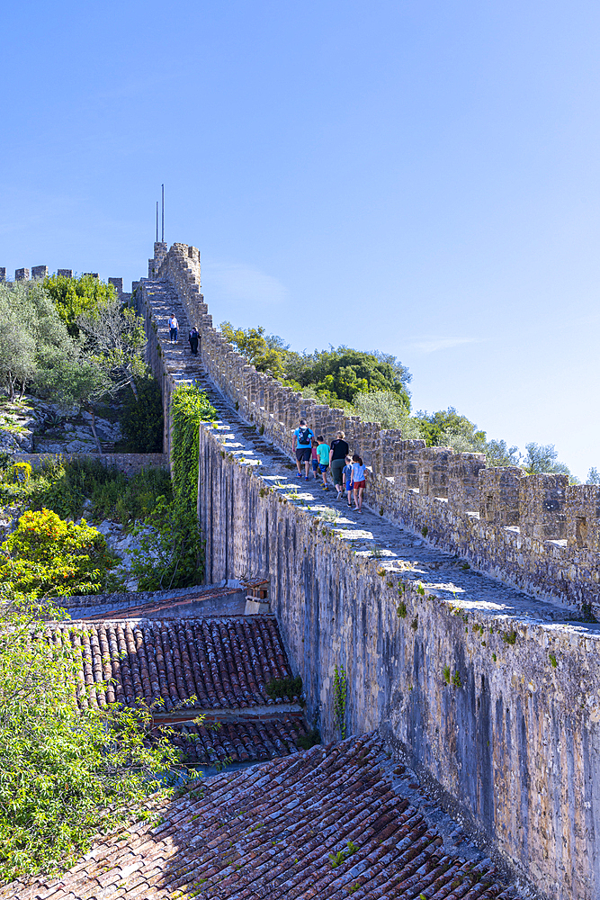 Europe, Portugal, Obidos. April 16, 2022. Tourists walking on the castle wall in Obidos.