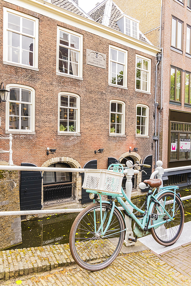 Europe, Netherlands, South Holland, Delft. April 25, 2022. Bicycle parked along a canal in Delft.