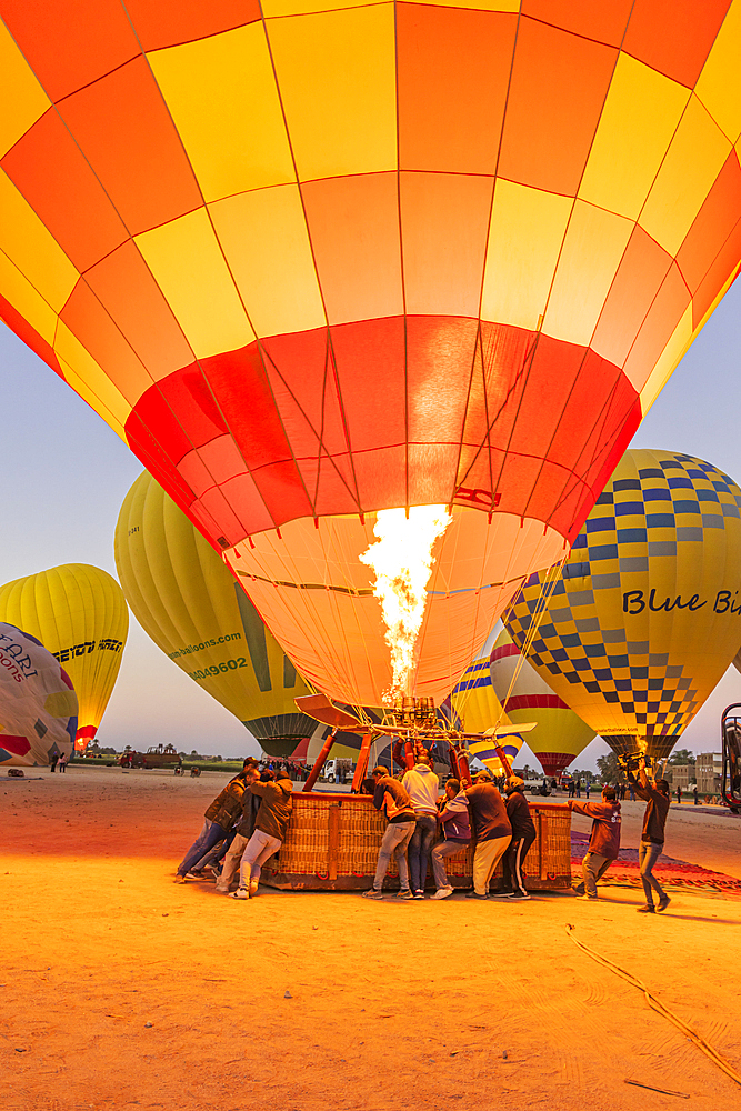 Luxor, Egypt. February 26, 2022. Hot air balloons being prepared for tourist rides at sunrise in Luxor.