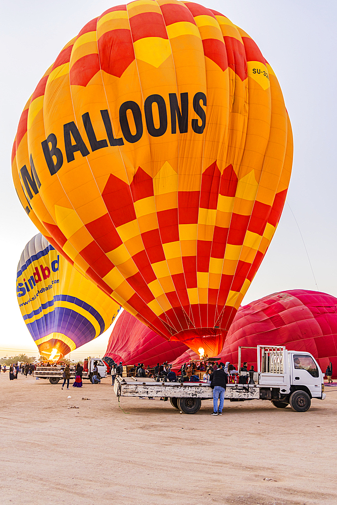 Luxor, Egypt. February 26, 2022. Hot air balloons being prepared for tourist rides at sunrise in Luxor.