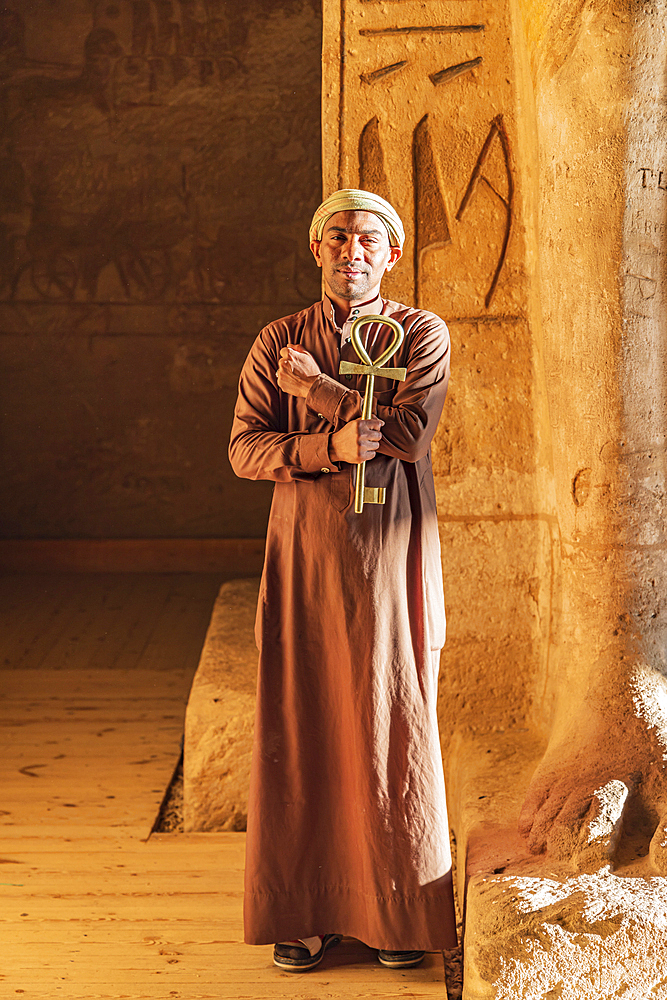 Abu Simbel, Aswan, Egypt. February 23, 2022. Caretaker holding a large key in the shape of an Ankh in the Great Temple of Ramesses II.