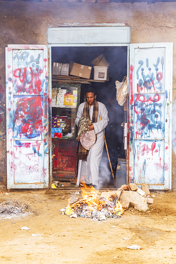 Birqash, Cairo, Egypt. February 18, 2022. Garbage burning outside a shop at the Birqash Camel Market outside Cairo.