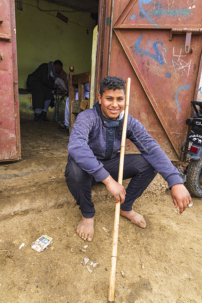 Birqash, Cairo, Egypt. February 18, 2022. A young man camel handler at a tea shop at the Birqash Camel Market outside Cairo.