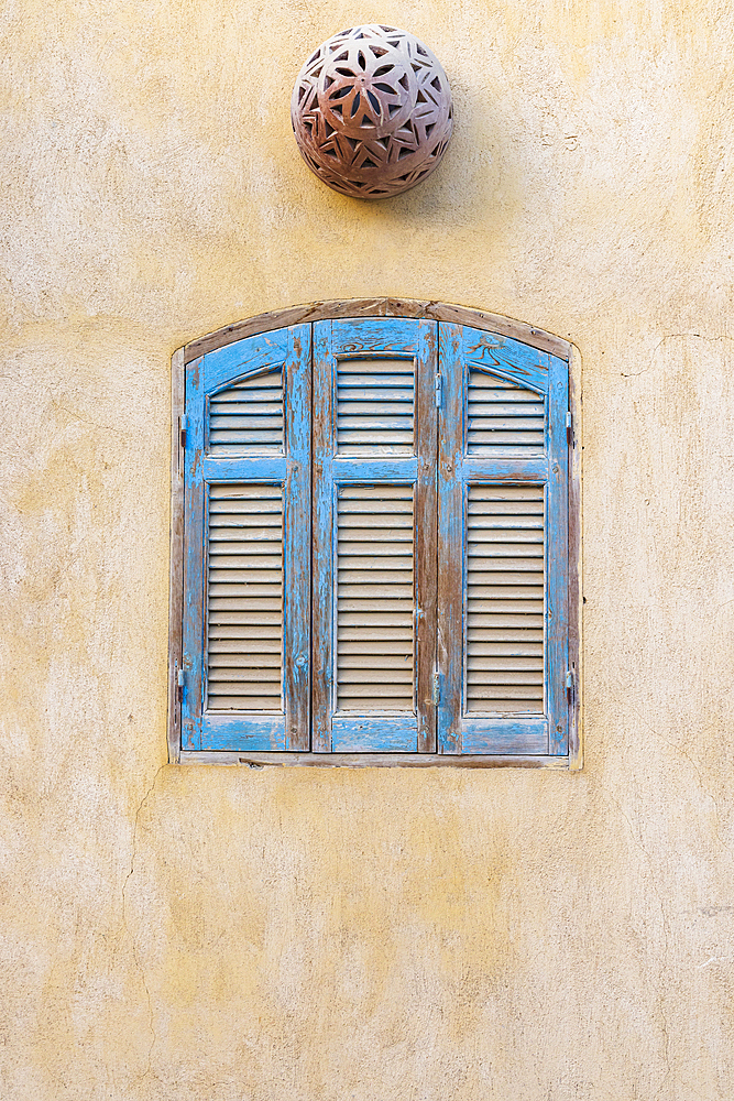 Faiyum, Egypt. Blue wooden shutters in the village of Faiyum.