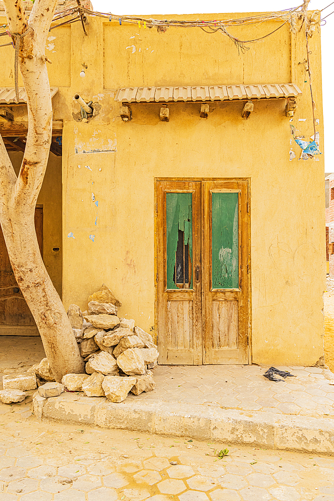 Faiyum, Egypt. Wooden door in a stucco building in Faiyum.