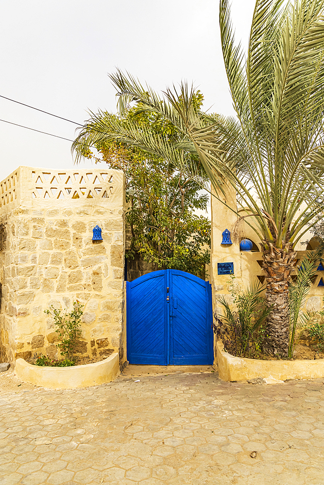 Faiyum, Egypt. Blue gate in a stone wall in Egypt.