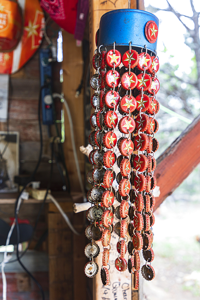 Comfort, Texas, USA. April 14, 2021. Chimes made of beer bottle caps in the Cartoon Saloon in the Texas hill country.