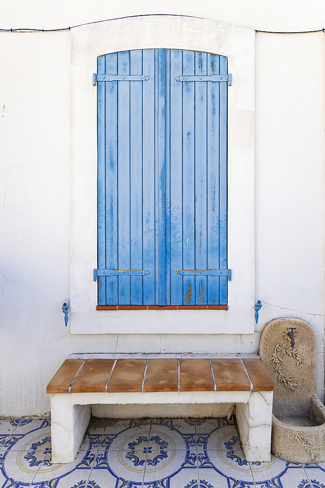 Saintes-Maries-de-la-Mer, Bouches-du-Rhone, Provence-Alpes-Cote d'Azur, France. Blue wooden window shutters in the south of France.