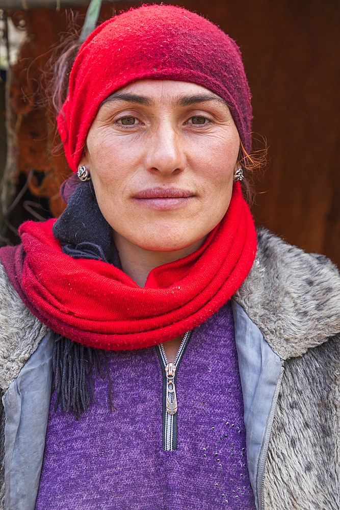 Gorno-Badakhshan Autonomous Province, Tajikistan. August 14, 2021. A woman wearing a red head scarf in the mountains of Tajikistan. Editorial Use Only