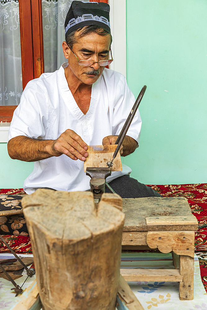 Istaravshan, Sughd Province, Tajikistan. August 19, 2021. Craftsman making wooden combs in Istaravshan. Editorial Use Only