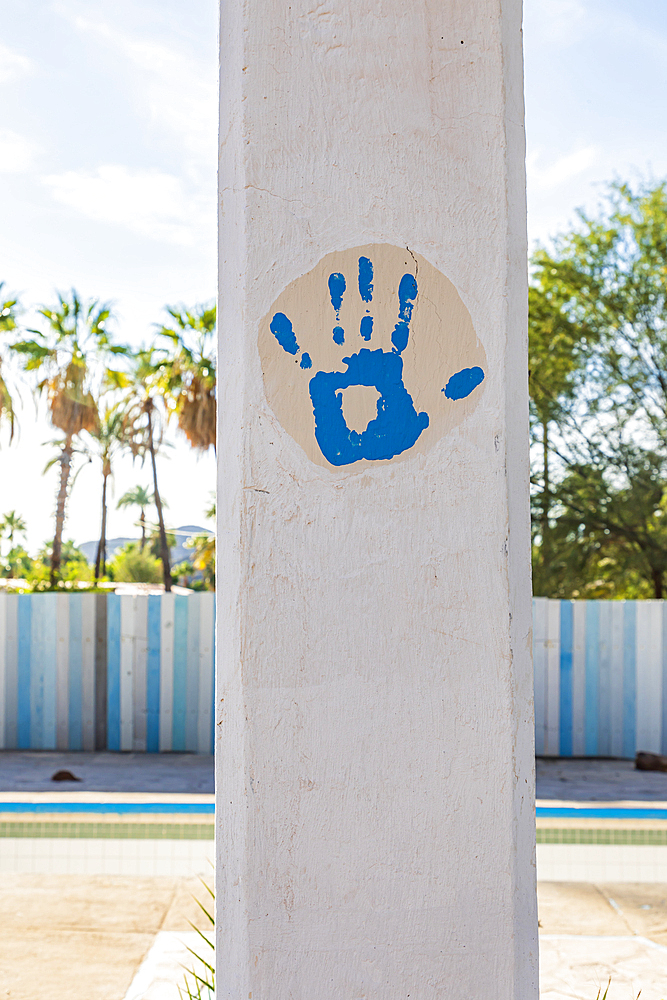 Playa el Burro, Mulege, Baja California Sur, Mexico. Blue paint handprint on a pillar in Baja.