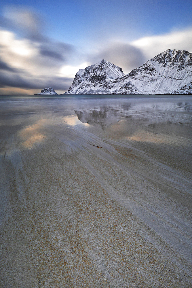 Long exposure to capture the afternoon light in Haukland beach, with snow on the mountain, Lofoten Islands, Nordland, Norway, Scandinavia, Europe