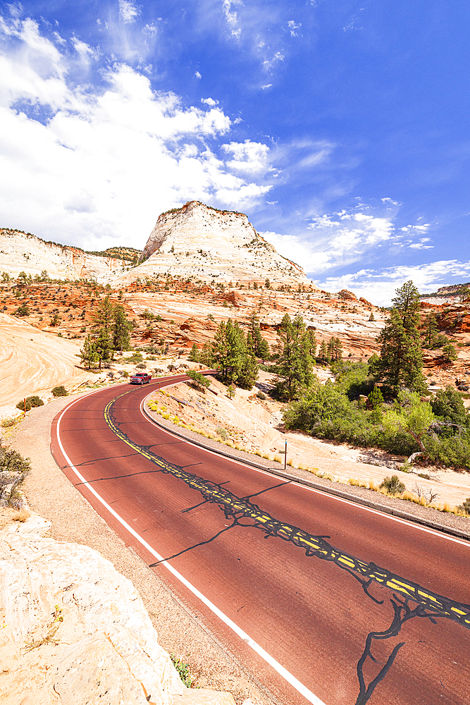 A car driving along scenic road in Zion National Park on a sunny day, Utah, United States of America