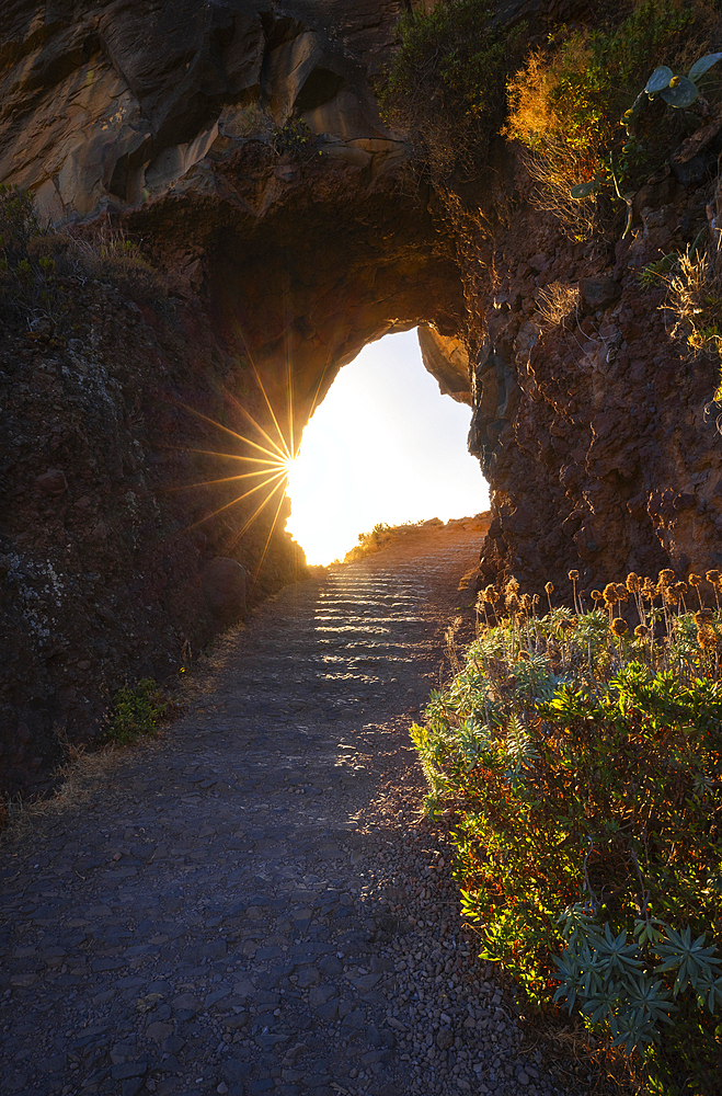 Sunset in a tunnel dug into the rock near Ponta do Sol. Madeira region, Portugal, Europe
