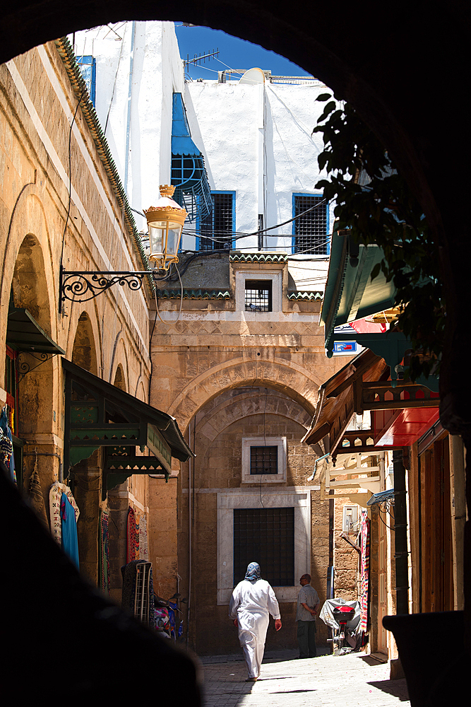 A woman and storefronts in the mazelike medina of Tunis, Tunisia North Africa, Africa