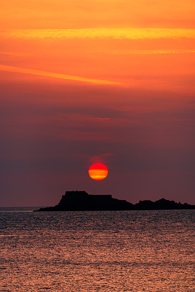 Colorful Sunset Behind the Silhouette of Fort National Seen from the Shoreline of Saint-Malo in Brittany France
