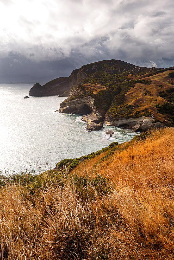 Golden headlands and dramatic cliffs dropping into the sea at Cape Farewell, Golden Bay, South Island, New Zealand.
