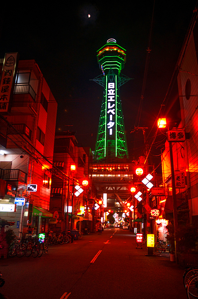 Night illumination of Shinsekai Tower in pitch black night, neon lights, Osaka, Honshu, Japan