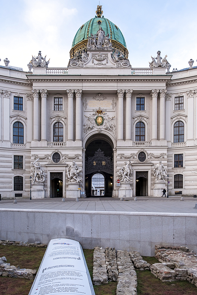 Vienna, Austria - View of Michaelerplatz, the historic square in front of Hofburg Palace's Michaelertor gate, featuring the excavated ruins of ancient Roman and medieval Vienna alongside Baroque architecture.