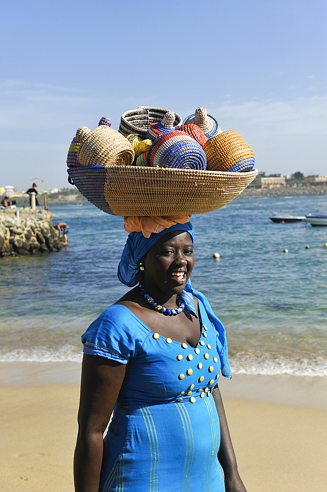 Woman selling basketry on a beach at Ngor island, Dakar, Senegal, West Africa