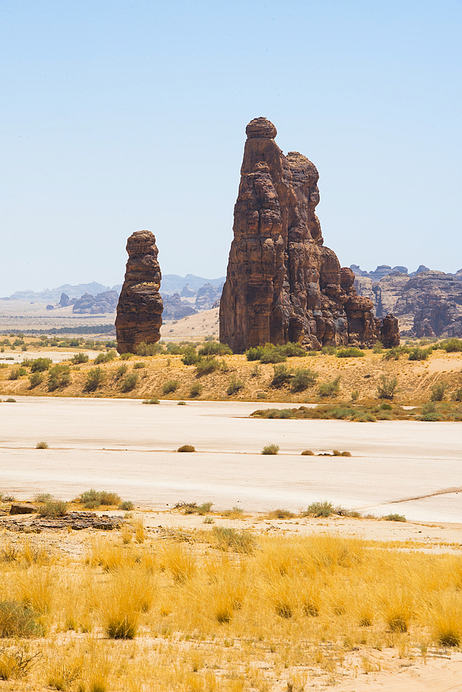 Sandstone rock tower beside a large dry salt lake in the Sharaan Nature Reserve, AlUla, Medina Province, Saudi Arabia, Middle East