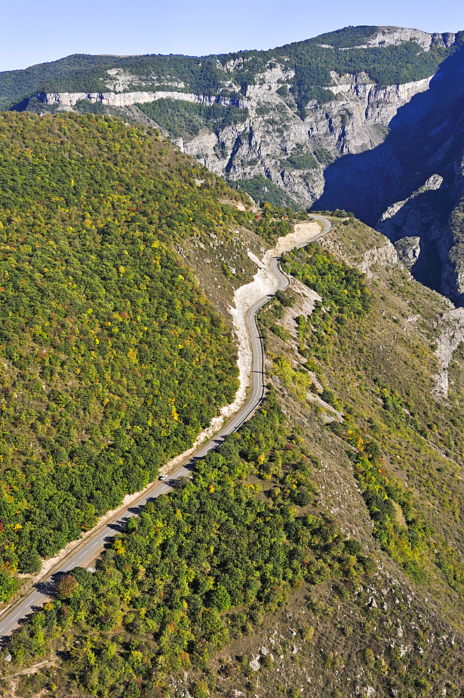 Road overhanging the deep gorge of the Vorotan River viewed from the cable car connecting the village of Halidzor, Syunik Province in southeastern Armenia, Eurasia