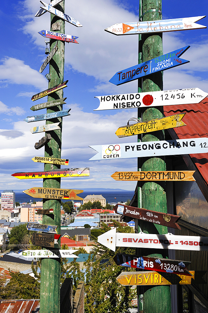 Sign post showing distance of some cities across the world from Punta Arenas, Strait of Magellan, Peninsula of Brunswick, Chile, South America