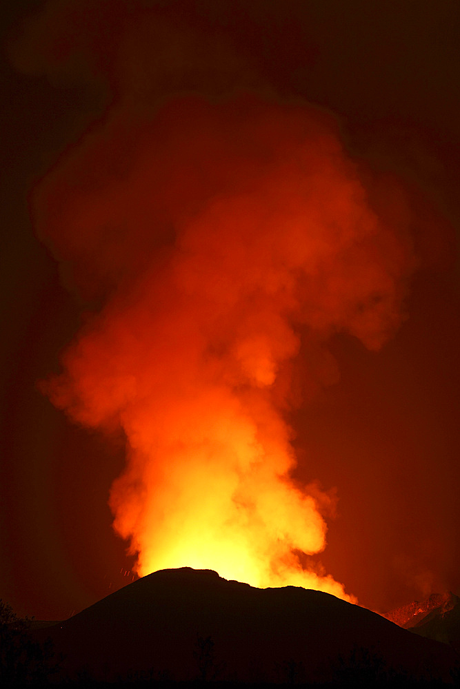 January 22, 2012 - Glowing lava in crater illuminating gas cloud above Nyamuragira Volcano, Kimanura Eruption.