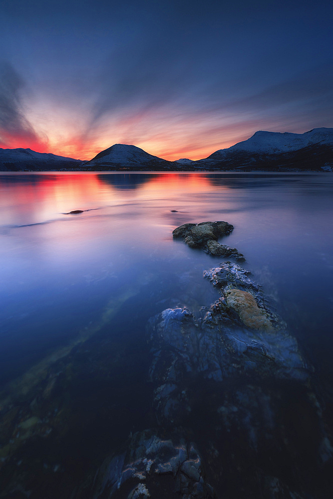 Sunset over Tjeldsundet, Troms County, Norway. Saetertinden and Harberget Mountains are visible in the background.