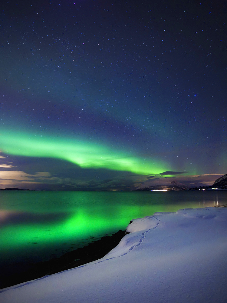 Aurora Borealis over Vagsfjorden in Troms County, Norway. Auroras are the result of the emissions of photons in the Earth's upper atmosphere.