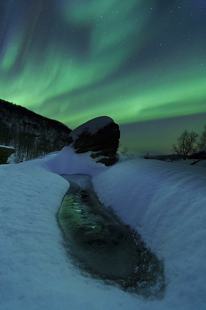Aurora Borealis over a frozen river, Klubbfjellet Mountain, Nordland, Norway.