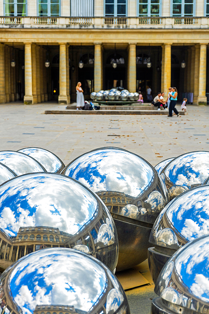 Mirror ball sculpture installation in forecourt of Jardin du Palais Royale on summer day