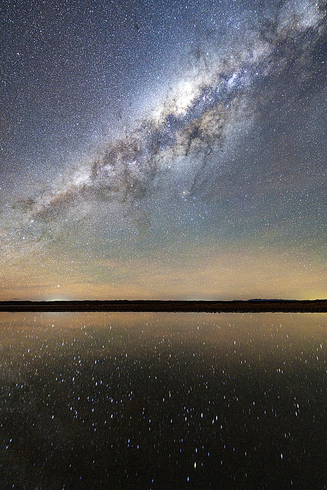 Starry night sky mirrored in a saline pool, Ojos del Mar, Tolar Grande, Argentina