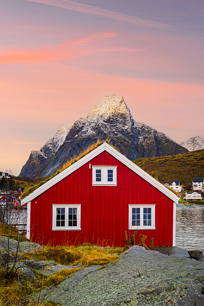 Red cabin with grass roof at sunset, Reine, Lofoten Islands, Norway