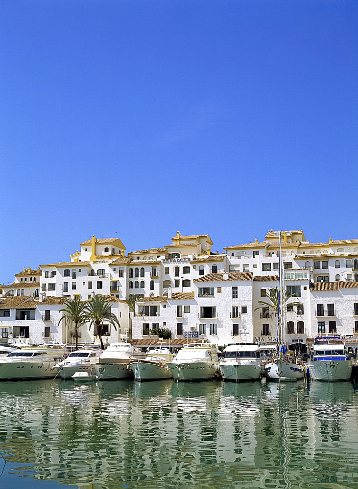 Boats in the harbour, and apartment buildings, at Puerto Banus, near Marbella, Costa del Sol, Andalucia, Spain, Europe