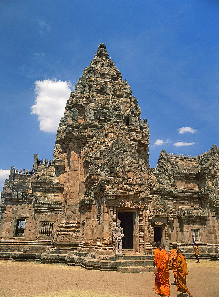 Buddhist monks in saffron robes in the central sanctuary of the Khmer temple of Prasat Hin Khao Phnom Rung on the Khorat plateau, Thailand, Southeast Asia, Asia