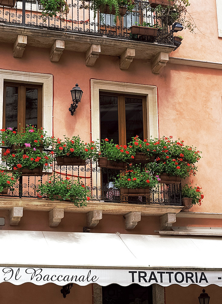 Flowers in window boxes on balconies, Taormina, Sicily, Italy, Europe